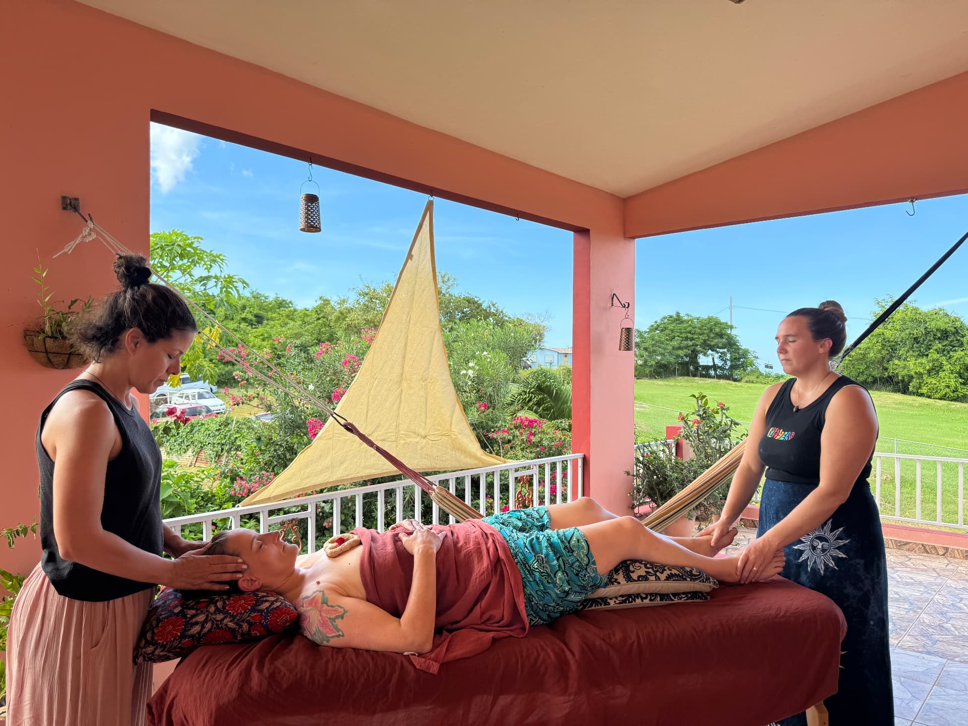 Students practising body therapy on the open-air porch