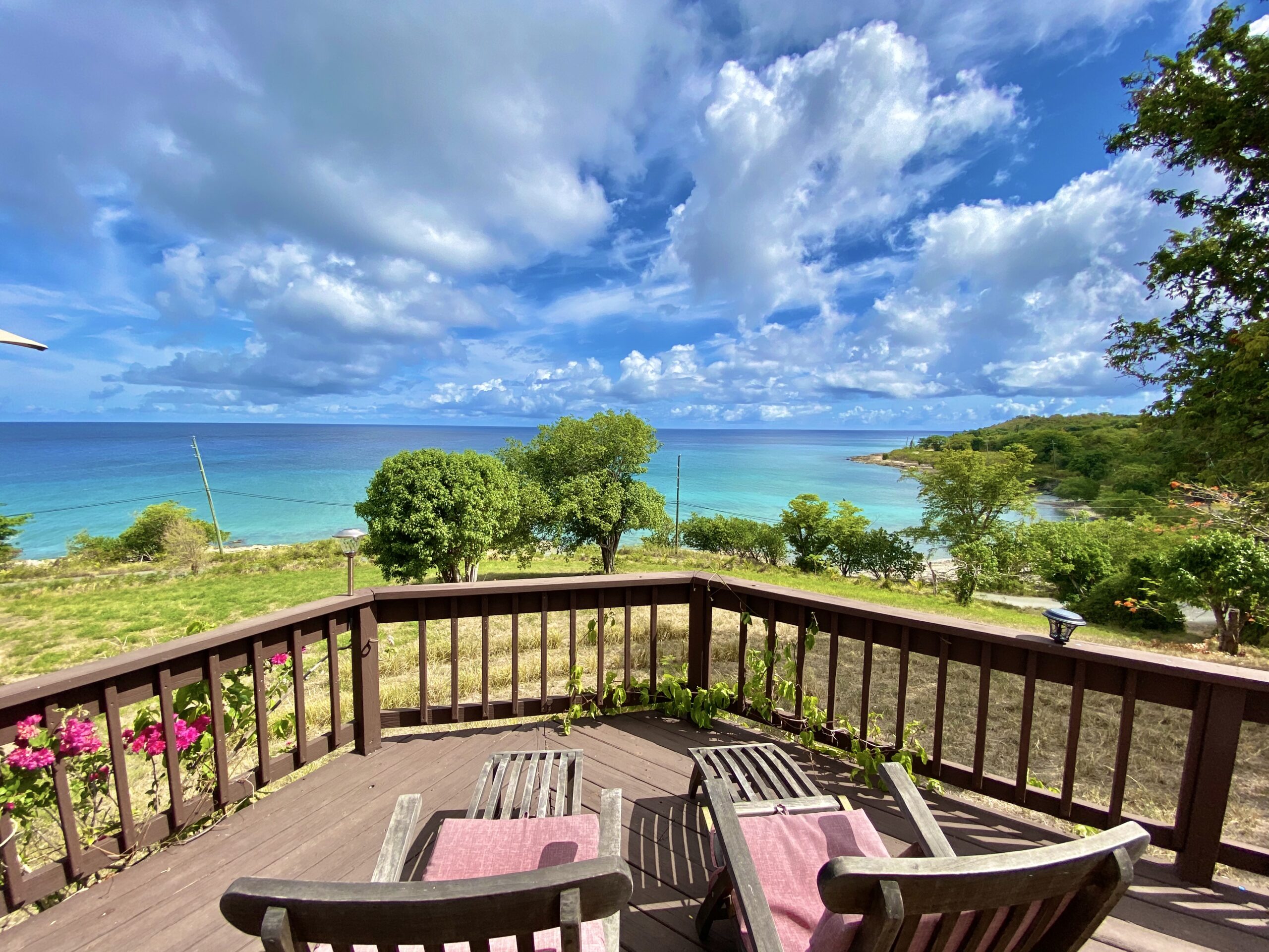 An ocean-view deck with lounge chairs above the Caribbean