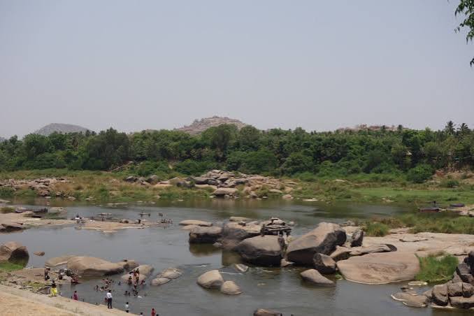 The Tungabhadra river winding through the boulder landscape at Hampi