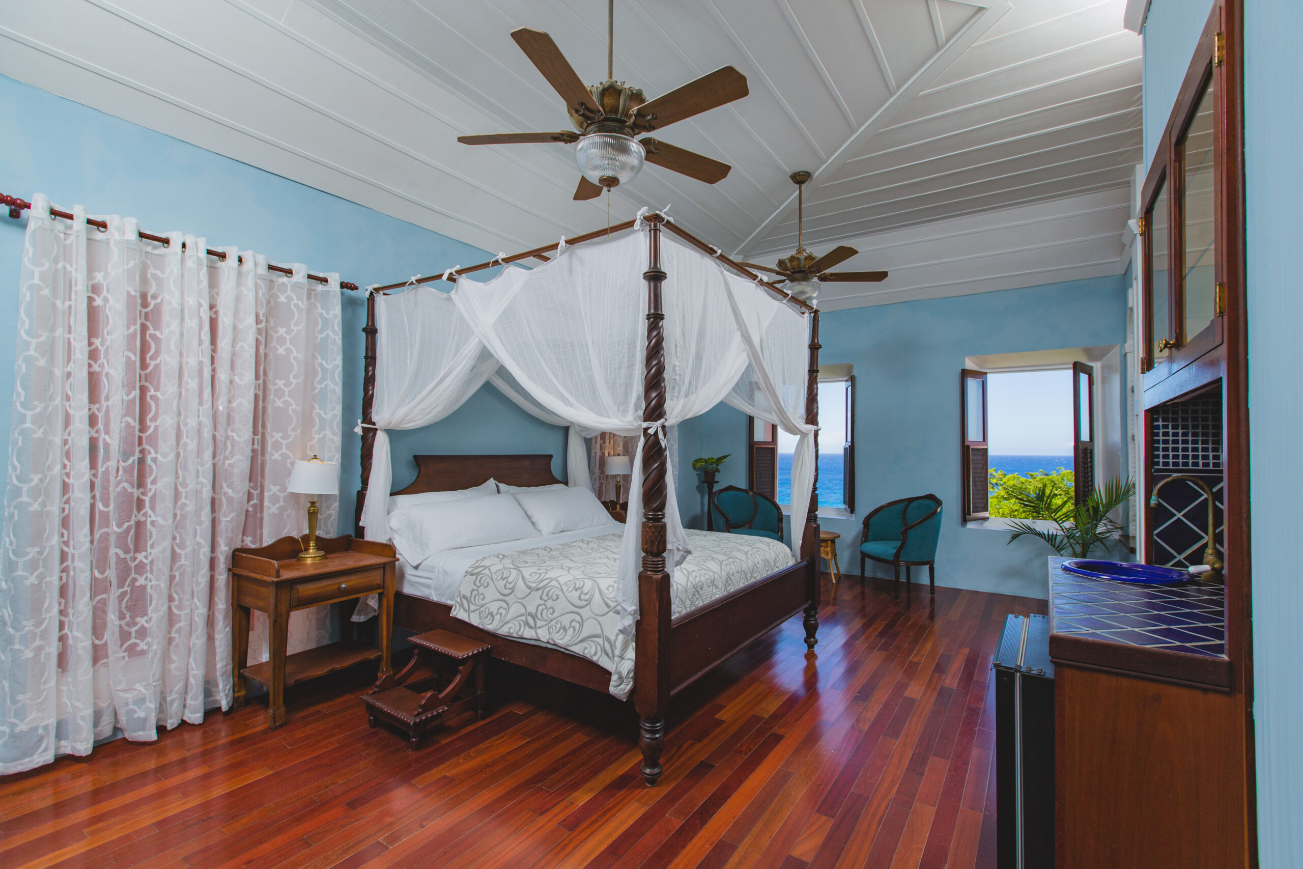 A restored four-poster queen suite at the Feather Leaf Inn